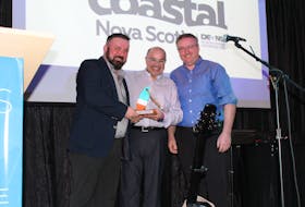 Joe MacEachern and Mike MacEachern (left and right) from Tapas and Trails accept The Buoys Event Award from Alain Bosse (middle).
 