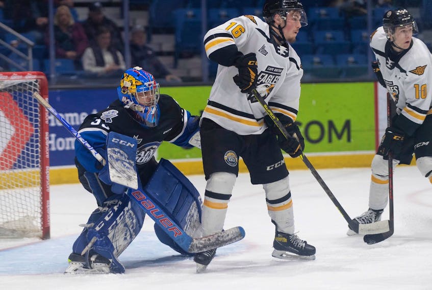 Carter McCluskey of the Cape Breton Eagles, right, stands in front of Saint John Sea Dogs goaltender Thomas Couture during Quebec Major Junior Hockey League action at TD Station in Saint John, Thursday. The Sea Dogs won the game 4-1. PHOTO CONTRIBUTED/MICHAEL HAWKINS, SAINT JOHN SEA DOGS.