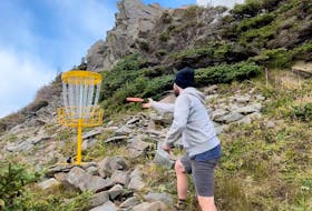 John Milley throws a disc while participating in an event in Rocky Harbour in October 2021. The course was set up in the area of the Lobster Cove Lighthouse.