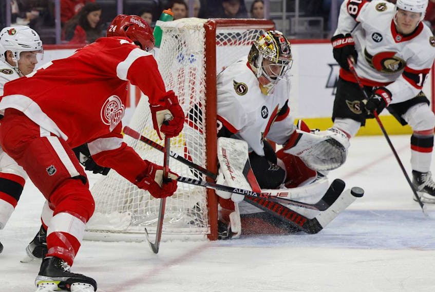Senators goaltender Mads Sogaard (33) makes a save on Red Wings centre Pius Suter (24) in the second period of Friday's game in Detroit.