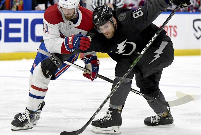 Canadiens' Paul Byron (41) and Tampa Bay Lightning;s Erik Cernak (81) compete for the puck on Saturday, April 2, 2022, in Tampa.