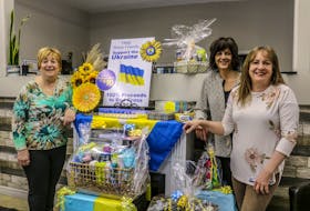 From left, Nancy MacLean, Colleen Verner and Janet Baker of Shear Friends Salon and Spa surround the salon's Ukraine fundraiser display. JESSICA SMITH/CAPE BRETON POST