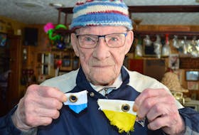 Sterling Hickox of Charlottetown shows all that is left of the Ukrainian flag he and his wife, Jane Wilson, were flying outside their home before vandals ripped it off its pole on the weekend.