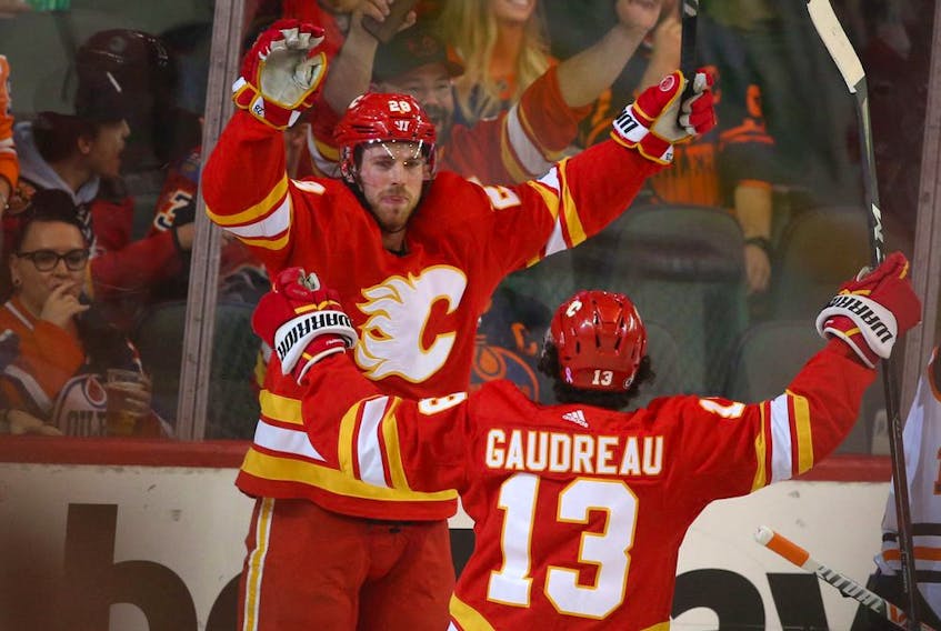 Calgary Flames forward Elias Lindholm celebrates a goal against the Edmonton Oilers with Johnny Gaudreau at Scotiabank Saddledome on Saturday, March 26, 2022.