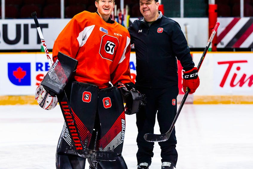 Ottawa 67's goaltending coach Andrew Mercer, right, shares a laugh with goaltender Collin MacKenzie during a team practice earlier this season at TD Place Arena in Ottawa. Mercer, originally of Coxheath, is in his first year with the Ontario Hockey League club. PHOTO CONTRIBUTED/JON HALPENNY, OTTAWA 67s.