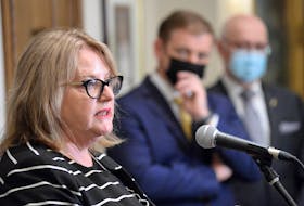 Newfoundland and Labrador Nurses Union president Yvette Coffey speaks to media at a news conference at Confederation Building in St. John's Tuesday, April 5. Looking on are Premier Andrew Furey and Health Minister Dr. John Haggie (right).