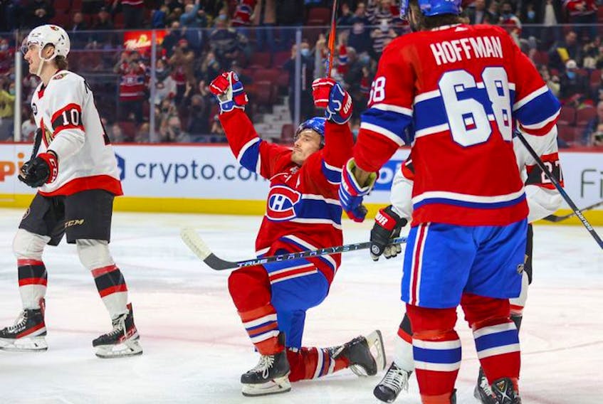Montreal Canadiens' Brendan Gallagher celebrates his goal  during first period of National Hockey League game against the Ottawa Senators in Montreal Tuesday, April 5, 2022.  Team-mate Mike Hoffman moves in to congratulate Gallagher while Sens Alex Formenton heads to the bench.