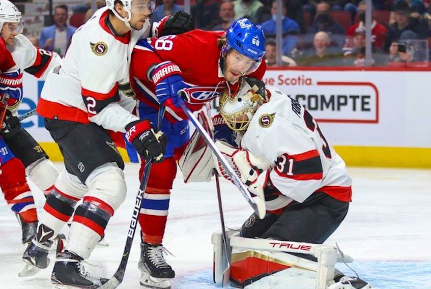 Ottawa Senators' Artem Zub pushes Montreal Canadiens' Mike Hoffman into goalie Anton Forsberg during first period of National Hockey League game in Montreal Tuesday, April 5, 2022.