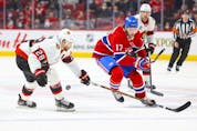 Montreal Canadiens' Josh Anderson has the puck knocked off his stick by Ottawa Senators' Connor Brown during first period of National Hockey League game in Montreal Tuesday, April 5, 2022.