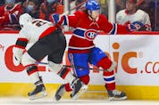Montreal Canadiens' Alexander Romanov sidesteps a check by Ottawa Senators' Artem Zub during first period of National Hockey League game in Montreal Tuesday. April 5, 2022.