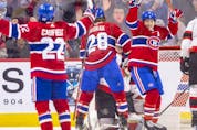 Montreal Canadiens' Brendan Gallagher turns to celebrate with Cole Caufield after Caufield's goral against the Ottawa Senators during second period of National Hockey League game in Montreal Tuesday, April 5, 2022.
