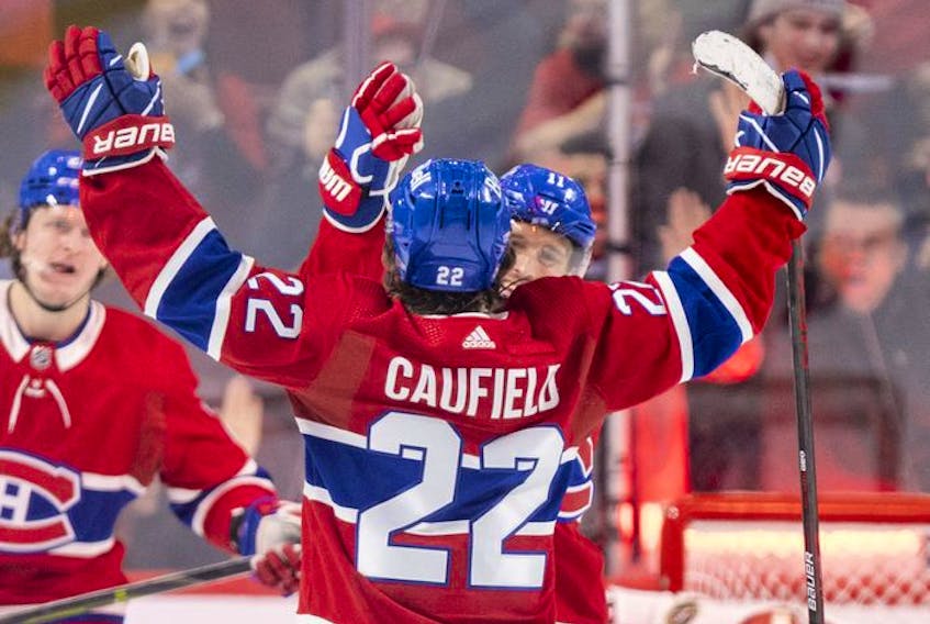 Montreal Canadiens' Brendan Gallagher celebrates with Cole Caufield after Caufield's goal against the Ottawa Senators during second period of National Hockey League game in Montreal Tuesday, April 5, 2022.