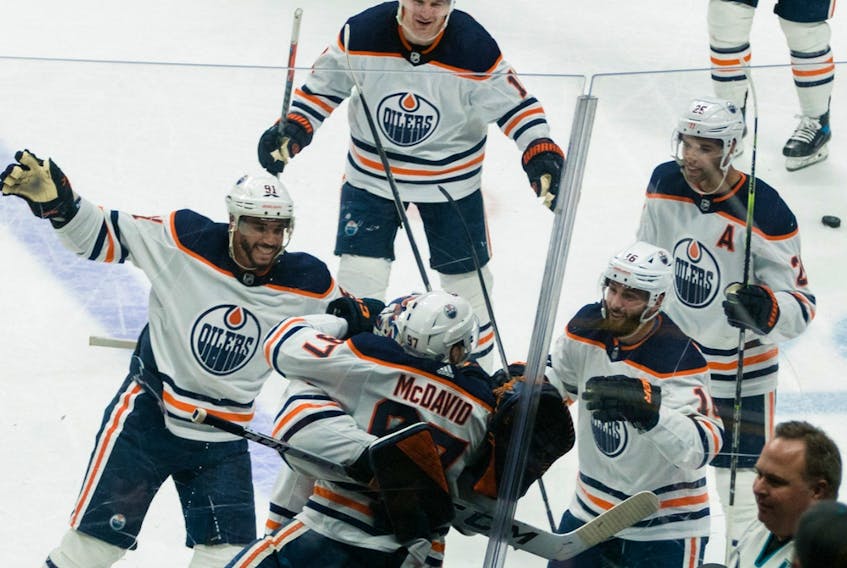 Edmonton Oilers center Connor McDavid (97) celebrates with teamates after scoring the winning goal against the San Jose Sharks during overtime at SAP Center in San Jose on Tuesday, April 5, 2022.
