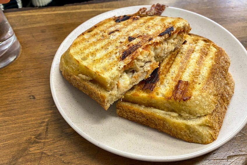 The lunch menu changes weekly at The Postmaster’s Bakery, with different sandwich options like this pulled chicken panini with brie, pickled pear and juniper mayo. Gabby Peyton photo