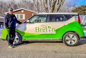 Erick Benner, owner of Breton Green Solutions, stands with his Kia Soul electric car in Sydney. He's had the vehicle for two months. CONTRIBUTED/Erick Benner