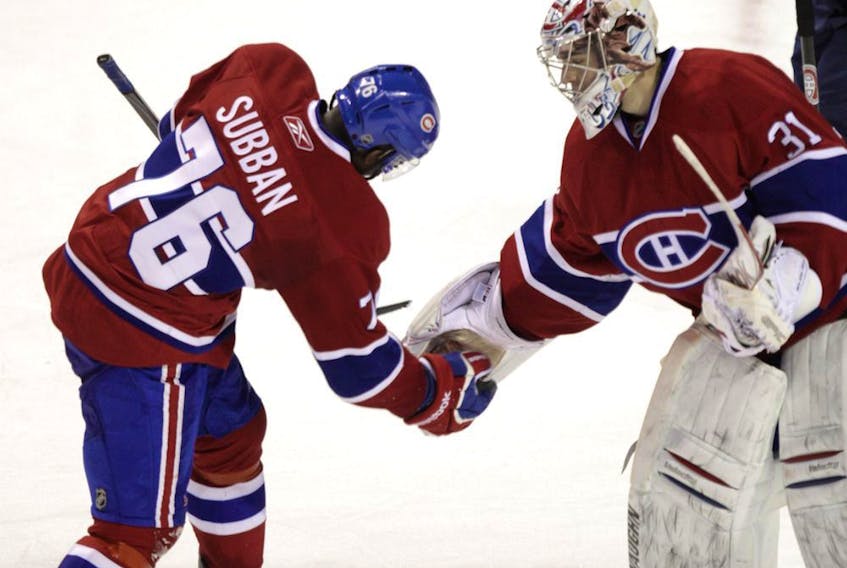 Goalie Carey Price and P.K Subban of the Montreal Canadiens do a triple-low-five to celebrate the team's 3-2 victory over the New York Rangers at the Bell Centre on Jan. 15, 2011.