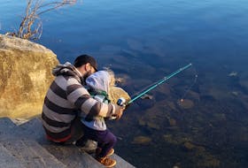 Vincent tries his luck at fishing with his father Anthony. KATY JEAN