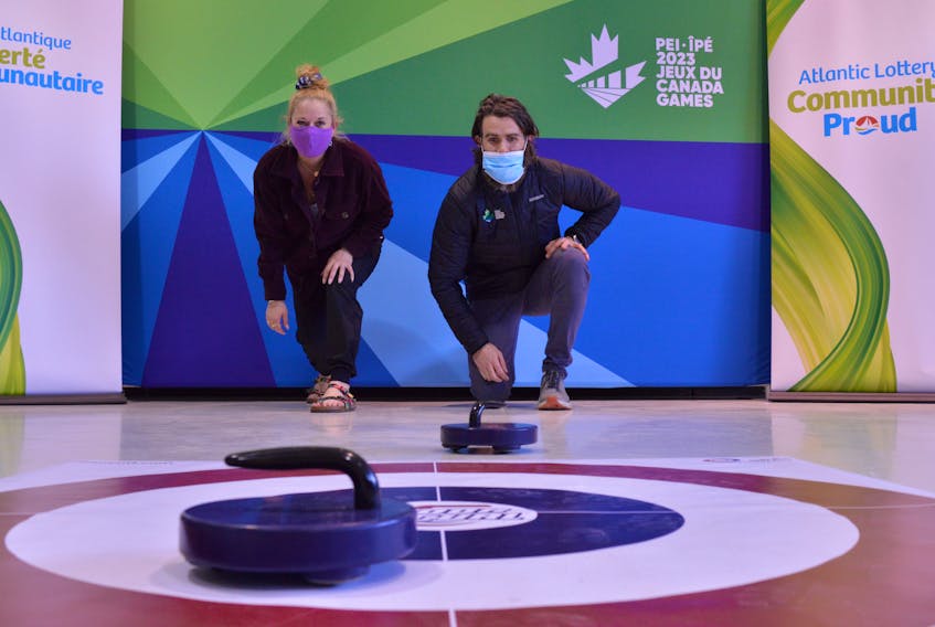 Volunteer Ambassador Jocelyne Waite, left, tries throwing a few rolling rocks with Sport Co-ordinator Travis McIsaac, at the grand opening for the Canada Games volunteer centre on April 7.  Waite will be helping folks sign up to volunteer at the 2023 Canada Winter Games. The centre, located at 121B Sandstone Rd. in Charlottetown, will be open Thursdays from 3 - 7 p.m. and Saturdays from 9 a.m. - 2 p.m. More hours will be added as the Games approach. 