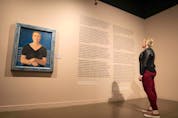 Stephanie Pahl, director of administration and culture at the Glenbow Museum, at the exhibit Uninvited: Canadian Women Artists in the Modern Moment at the Glenbow at the Edison. The painting is Portrait of Mrs. Carl Schaefer (Nee Lillian Evers), 1933 by Yulia Biriukova.