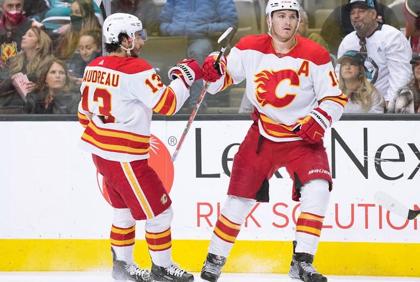 Calgary Flames forward Matthew Tkachuk is congratulated by Johnny Gaudreau after scoring a goal against the San Jose Sharks at SAP Center in San Jose, Calif., on Thursday, April 7, 2022.
