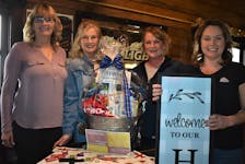 Moms Stronger Together members Mimi MacKinnon-Woods (left), Mary Teed, Chrissy Bonnell and Judy Gamble with the basket and porch sign they’re currently selling tickets on with all proceeds going towards Heart’s Haven Memorial Park in Debert. Missing from photo is member Vangie Beal.