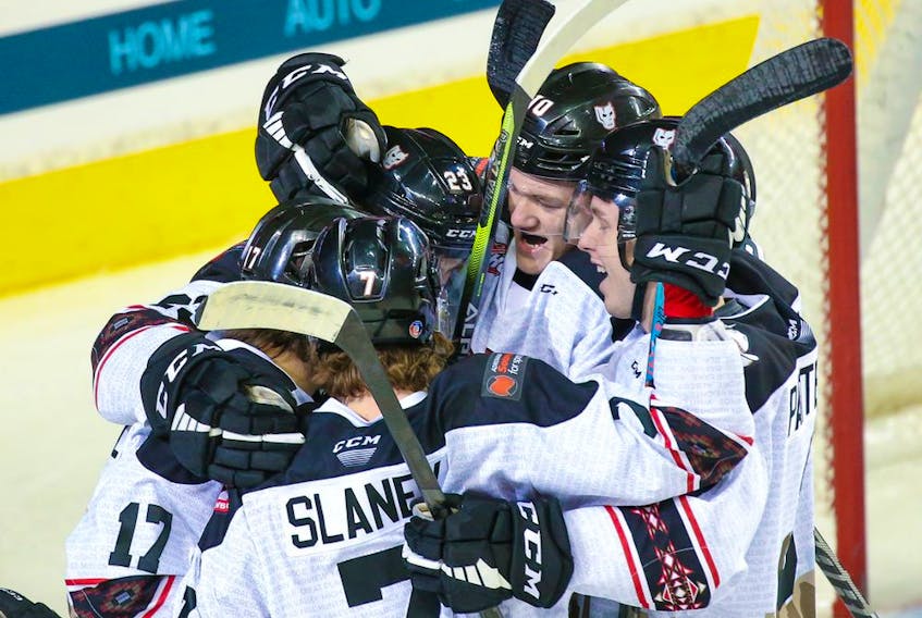 The Calgary Hitmen celebrate forward Steel Quiring’s goal against the Swift Current Broncos at the Scotiabank Saddledome on Sunday, April 3, 2022. 