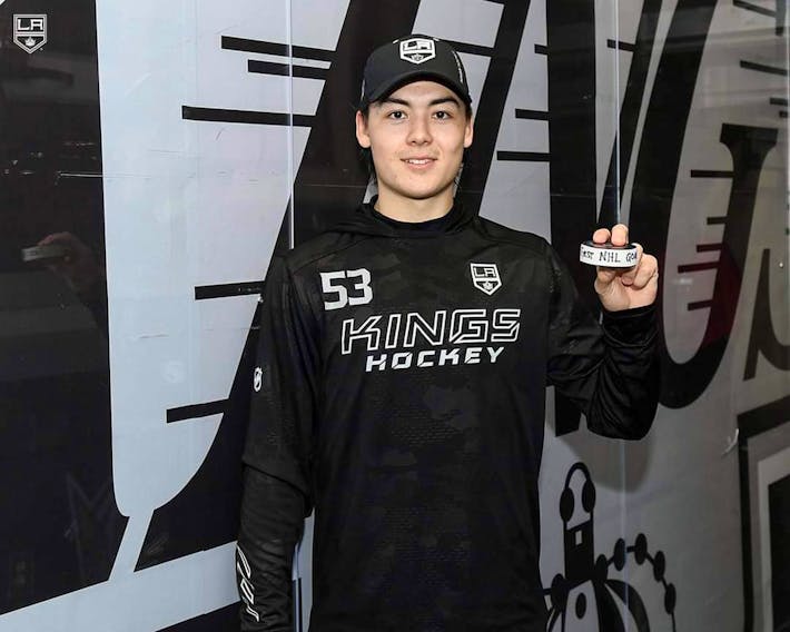 Los Angeles Kings defenceman Jordan Spence proudly displays the puck from his first National Hockey League goal against Seattle on March 26. 