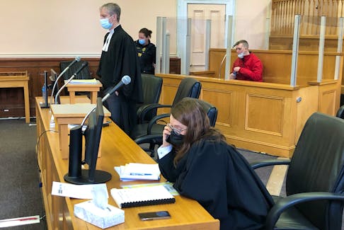 Shane Clarke sits in the dock in Newfoundland and Labrador Supreme Court in St. John's behind his lawyer, Jon Noonan, and prosecutor Elaine Reid shortly before the start of his sentencing hearing April 8.
