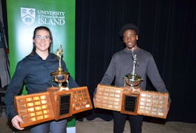 Jolena Gillard and Elijah Miller pose with the UPEI athletes-of-the-year trophies following the athletic awards celebration at the P.E.I. Brewing Company in Charlottetown on April 7.