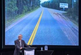 Commission counsel Roger Burrill displays a photo that shows the stretch of Plains Road where Heather O'Brien and Kristen Beaton were murdered by Gabriel Wortman, at the Mass Casualty Commission inquiry in Halifax on March 31, 2022.  