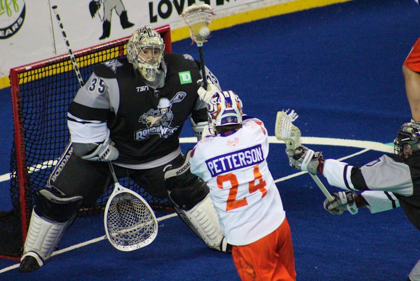Halifax Thunderbirds forward Clarke Petterson fires a shot at Calgary Roughnecks goalie Christian Del Bianco during a National Lacorsse League game Friday night in Calgary. - NATIONAL LACROSSE LEAGUE