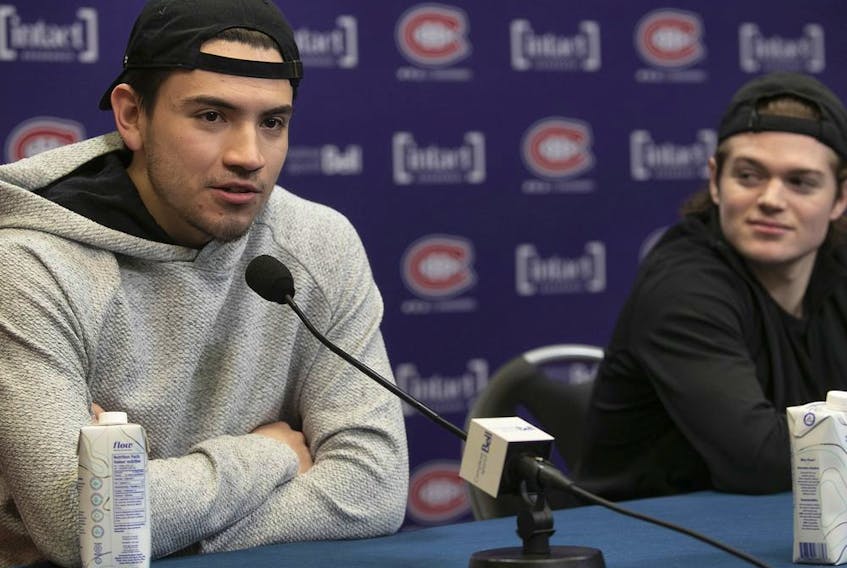 Nick Suzuki (left) and Cole Caufield answer questions during Canadiens’ post-mortem news conference Saturday at the Bell Sports Complex in Brossard.