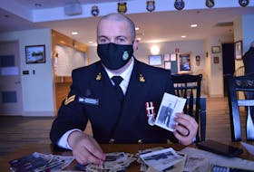 Sailor 1st Class Ryan Lawrence holds a photo of his grandfather Joseph Lawrence taken while he was in the Canadian navy during the Second World War.