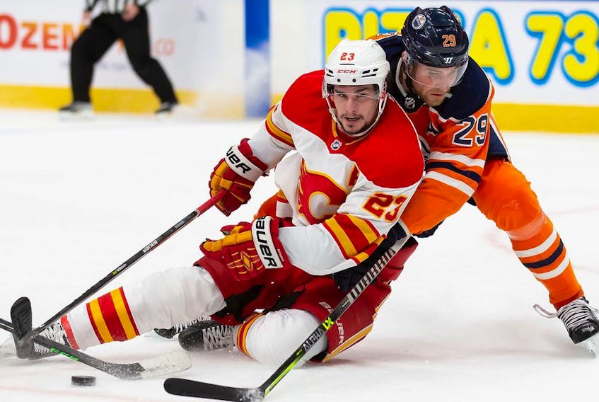  Leon Draisaitl (29) of the Edmonton Oilers battles Sean Monahan (23) of the Calgary Flames at Rogers Place on Jan. 22, 2022, in Edmonton.