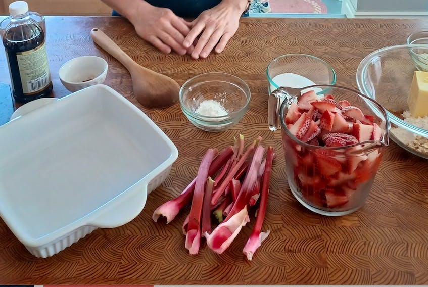 Cheryl Rathgeber prepares the ingredients she needs to make strawberry rhubarb crisp. The delicious dessert is particularly popular in the spring. - Mackenzie Rathgeber