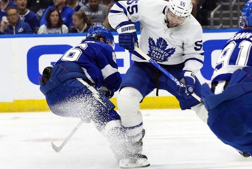 May 8, 2022; Tampa, Florida, USA; Tampa Bay Lightning right wing Nikita Kucherov (86) and Toronto Maple Leafs defenseman Mark Giordano (55) go after the loose puck during the second period of game four of the first round of the 2022 Stanley Cup Playoffs at Amalie Arena.  