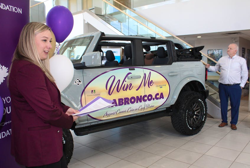 Jenna Dunlop, left, the Cape Breton Regional Hospital Foundation's fund development officer, and John Gillis of Colbourne Ford unveil the grand prize of the foundation's first vehicle lottery, a 2021 Bronco Outerbanks with a sport tent worth more than $65,000. Proceeds from the fundraiser will support the Cancer Care at Home campaign. ARDELLE REYNOLDS/CAPE BRETON POST
