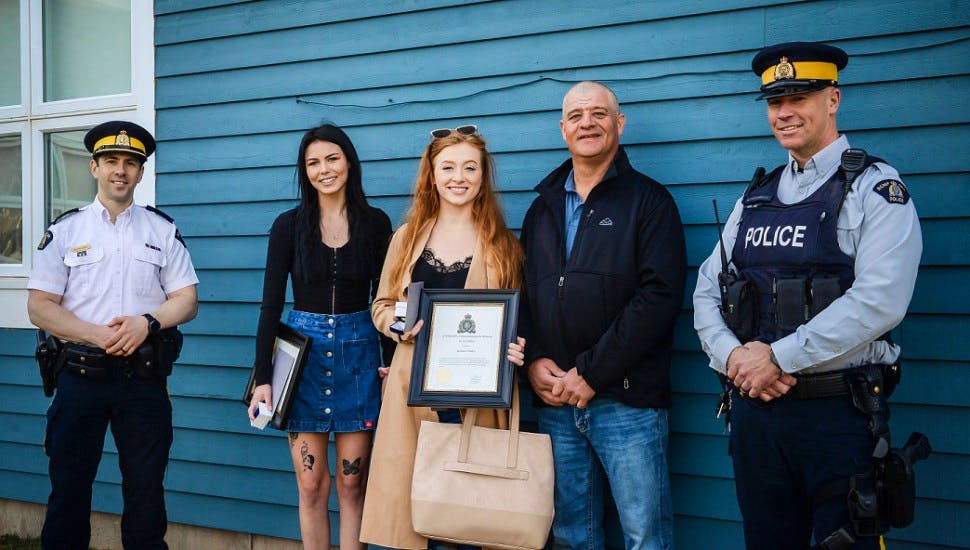 Supt. Kevin Lewis, left, Emily Chaulker, Jasmine Finley, Jamie Matthews and Const. Jamie Patterson celebrate Chaulker and Finley being awarded a civilian bravery commendation by the RCMP. Chaulker and Finley rescued Matthews from a cottage fire in Tignish on June 12, 2021.