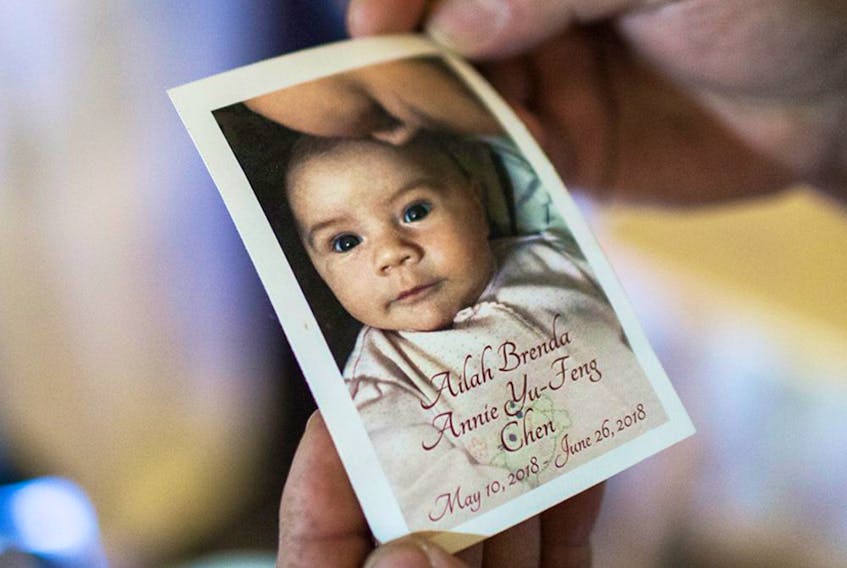 Alex Chen holds a photo of his daughter Ailah, who he and his wife Kristin lost to sudden infant death syndrome in June 2018.