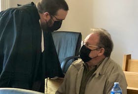 Robert Layman (right) speaks with his lawyer, Robert Hoskins, during a break in his trial Monday, May 9, in Newfoundland and Labrador Supreme Court in St. John's.