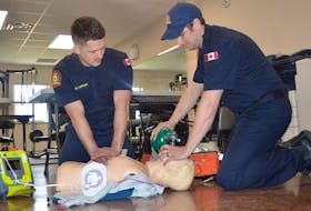 Firefighters Nolan Latham, left and Michael Bourgeois take in medical first responders' training session on Wednesday at Sydney Fire Station 2 on Victoria Road. IAN NATHANSON/CAPE BRETON POST