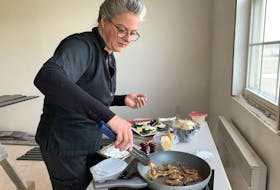Chef Nicole Hopkins cooks up some pan fried clams in her makeshift cooking corner is what will soon be the Salt Banker restaurant in Clark’s Harbour. “We’re going to treat clams a  little differently here,” she said.  KATHY JOHNSON