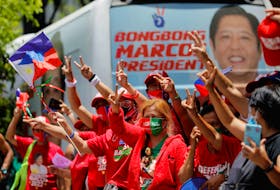 FILE PHOTO: Supporters of presidential candidate Ferdinand "Bongbong" Marcos Jr. gesture and celebrate as partial results of the 2022 national elections show him with a wide lead over rivals, outside the candidate's headquarters in Mandaluyong City, Philippines, May 10, 2022. REUTERS/Willy Kurniawan  Supporters of presidential candidate Ferdinand (Bongbong) Marcos Jr. gesture and celebrate as partial results of the 2022 national elections showed him with a wide lead over rivals, outside the candidate's headquarters in Mandaluyong City, Philippines on Tuesday. REUTERS/Willy Kurniawan