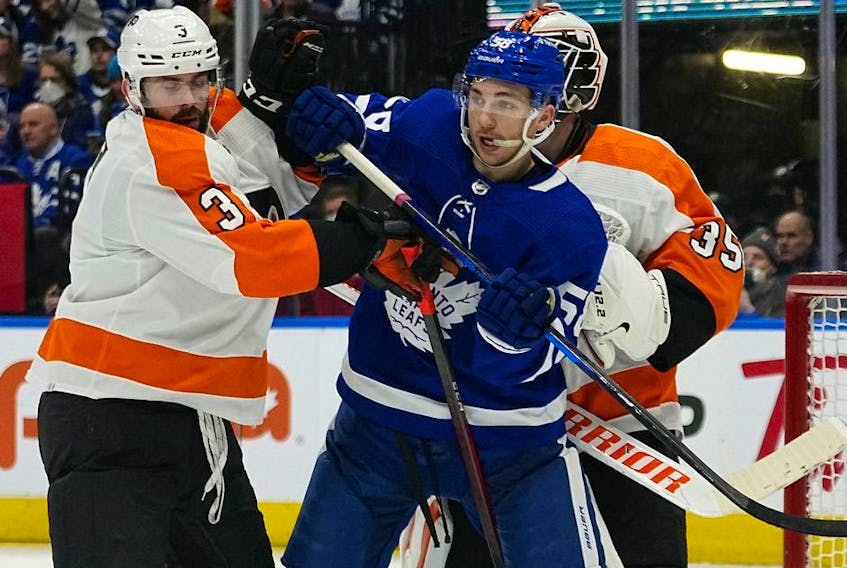 Toronto Maple Leafs forward Michael Bunting and Philadelphia Flyers defenseman Keith Yandle battle for position during the third period at Scotiabank Arena. 