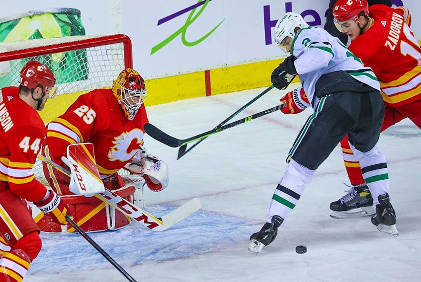  Calgary Flames goaltender Jacob Markstrom and Flames players Erik Gudbranson and Nikita Zadorov stop a Dallas Stars shot during Game 5 of their Stanley Cup playoff series in Calgary on Wednesday, May 11, 2022.