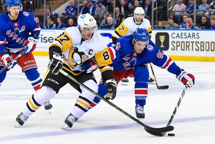Pittsburgh Penguins centre Sidney Crosby (87) battle with New York Rangers defenceman Justin Braun (61) during an NHL playoff game at Madison Square Garden. - Dennis Schneidler-USA TODAY Sports