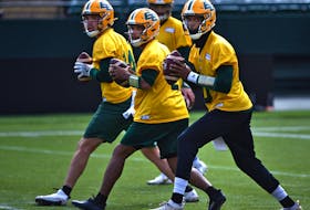 Quarterbacks Kai Locksley (10), Tre Ford (2), Mike Beaudry (14) drop back to pass during the first day of Edmonton Elks rookie camp at Commonwealth Stadium in Edmonton on Wednesday, May 11, 2022.