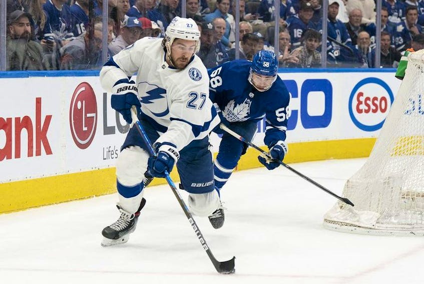 May 10, 2022; Toronto, Ontario, CAN; Toronto Maple Leafs left wing Michael Bunting battles for the puck with Tampa Bay Lightning defenseman Ryan McDonagh during the third period of game five of the first round of the 2022 Stanley Cup Playoffs at Scotiabank Arena.