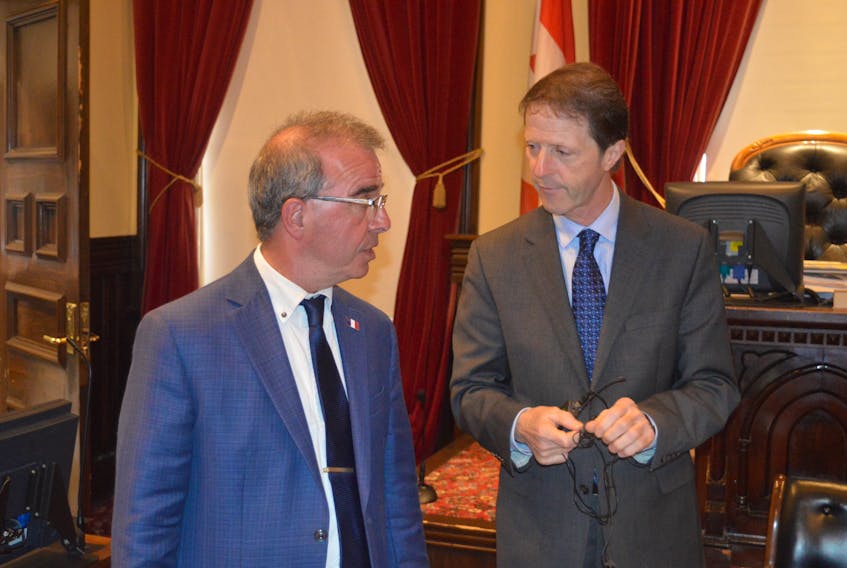 In this file photo, Charlottetown Mayor Philip Brown, left, speaks with Peter Kelly, who was terminated as chief administrative officer on May 12.