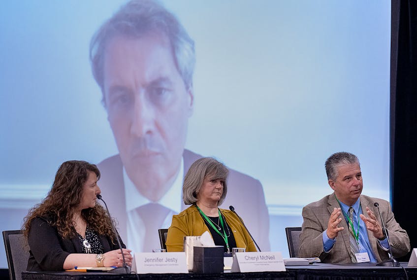 Michael Hallowes looks on as Jennifer Jesty, Cheryl McNeil and Paul Mason, left to right,  participate in a roundtable related to public alert systems at the Mass Casualty Commission inquiry into the mass murders in rural Nova Scotia on April 18/19, 2020, in Dartmouth, N.S. on Thursday, May 12, 2022. Gabriel Wortman, dressed as an RCMP officer and driving a replica police cruiser, murdered 22 people. THE CANADIAN PRESS/Andrew Vaughan
